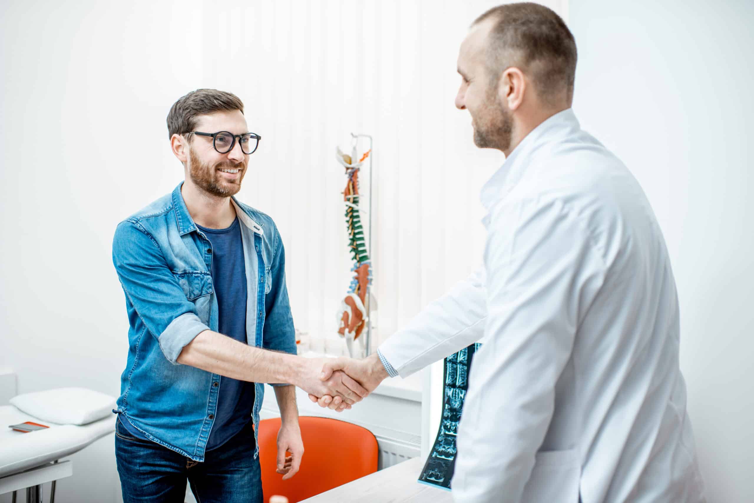 Patient handshaking with doctor at the office