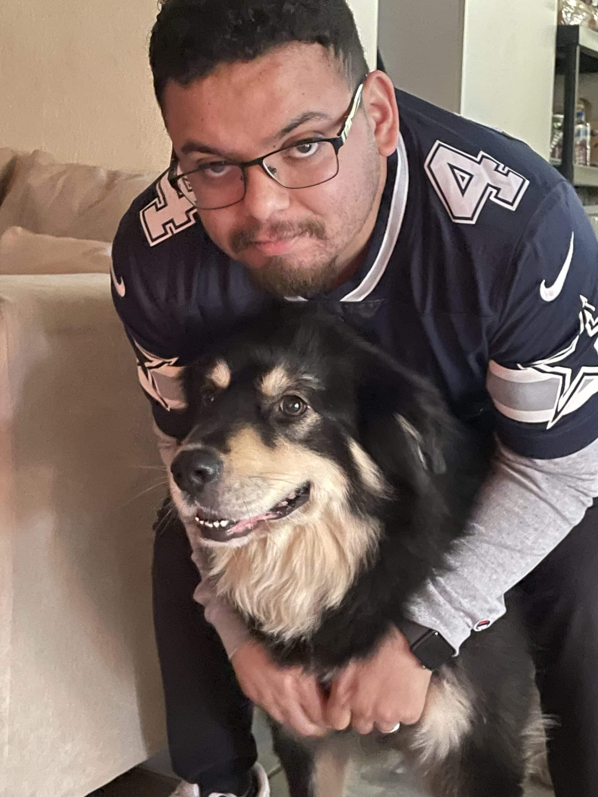 bryan acosta in his natural habitat in a dallas cowboys jersey with his dog Nero