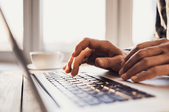 user typing on a laptop