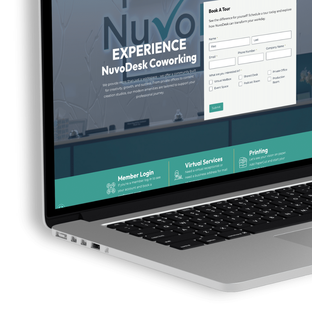 Close-up of MacBook showing NuvoDesk website with visible Book A Tour form