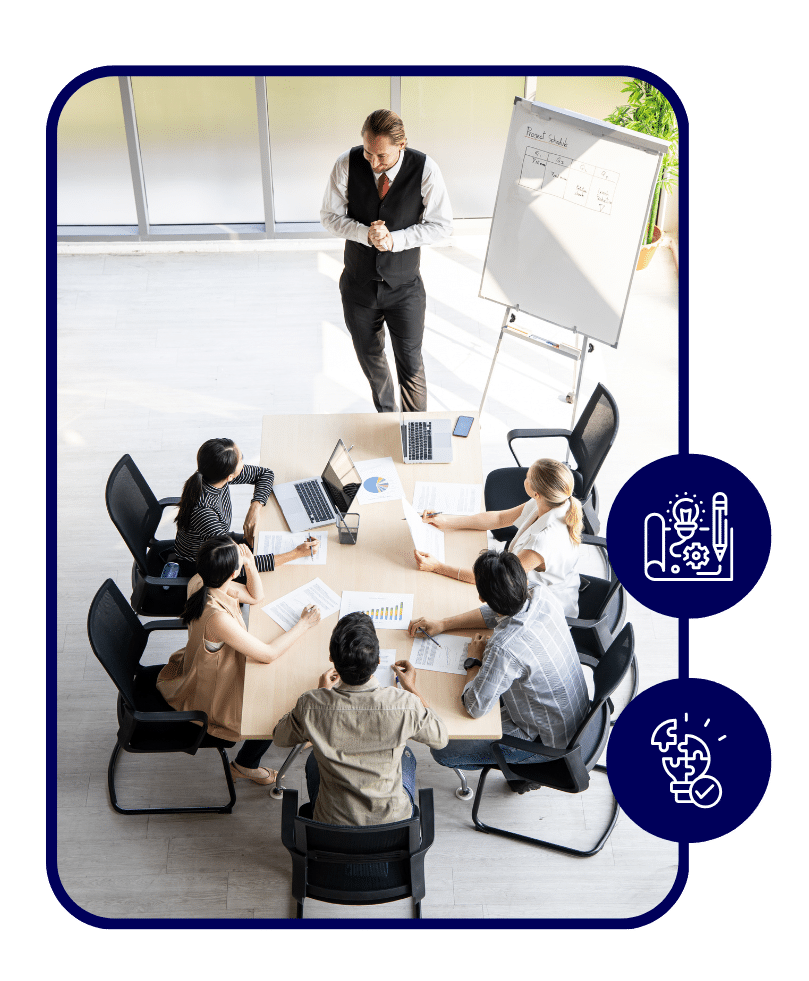 ATMA Blog Graphics - 2025-08-18T094123802 » Advent Trinity Marketing Agency Business leader presenting marketing strategy to team in conference room – professionals discussing growth plans with charts and laptops.
